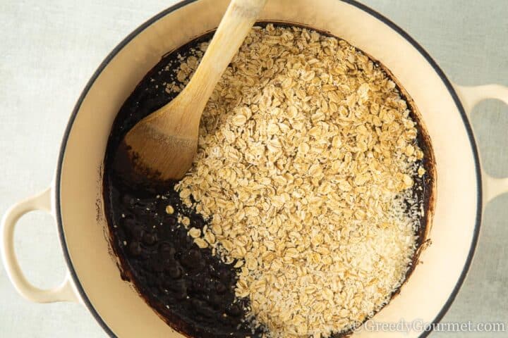 add oats and coconut to chocolate.
