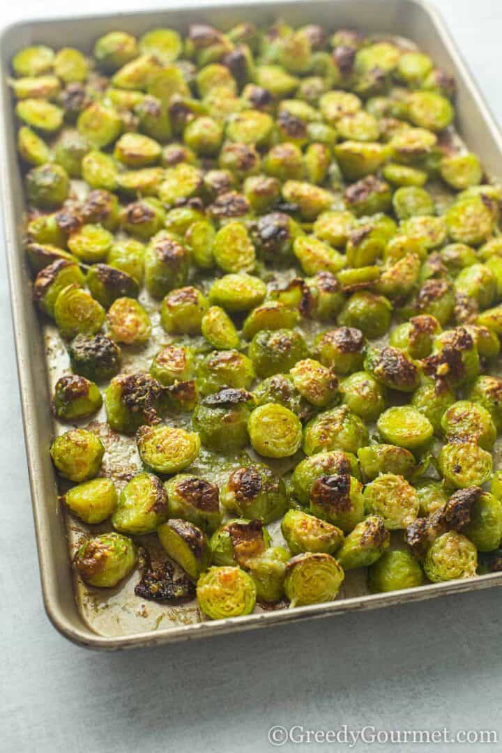 Cooked Roasted parmesan brussels sprouts in a baking dish.