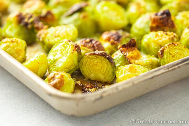 Cooked Roasted parmesan brussels sprouts in a baking dish.