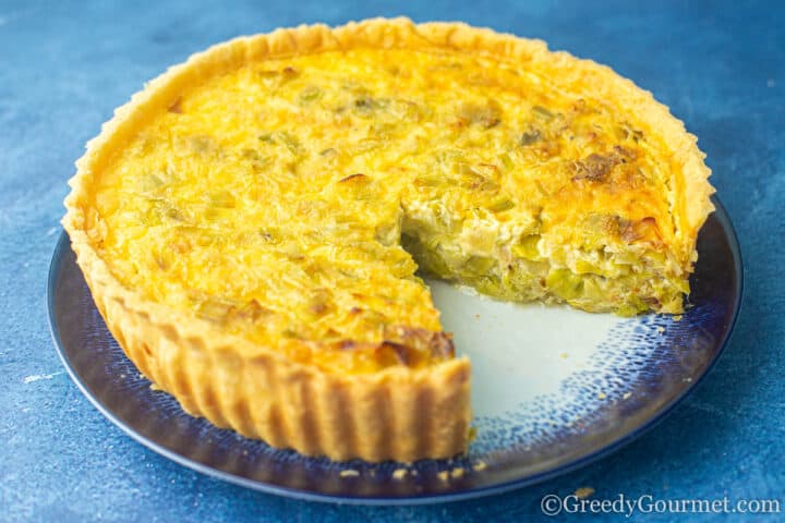 Creamy leek tart with a slice taken from it.