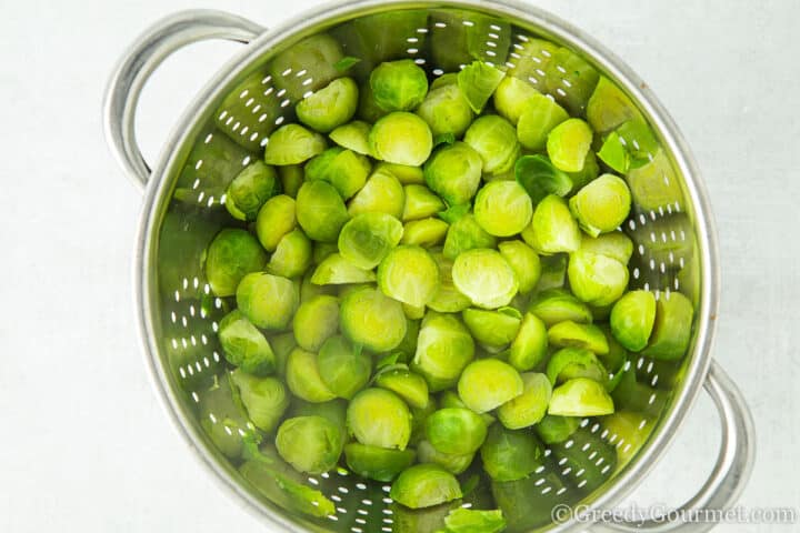 Parboiled brussels sprouts in a colander. 