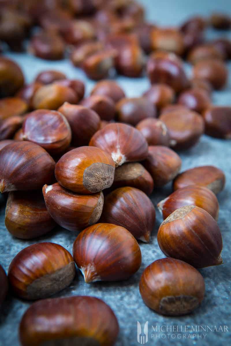 raw chestnuts laid on a table.