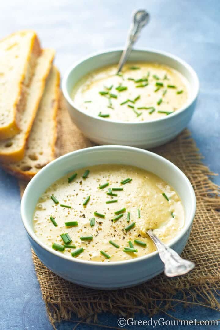 Potato fennel soup served in bowls with bread.