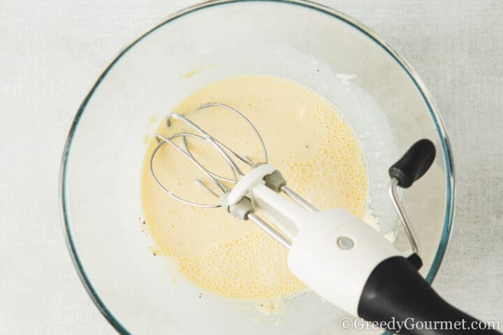 mixing carbonara sauce.