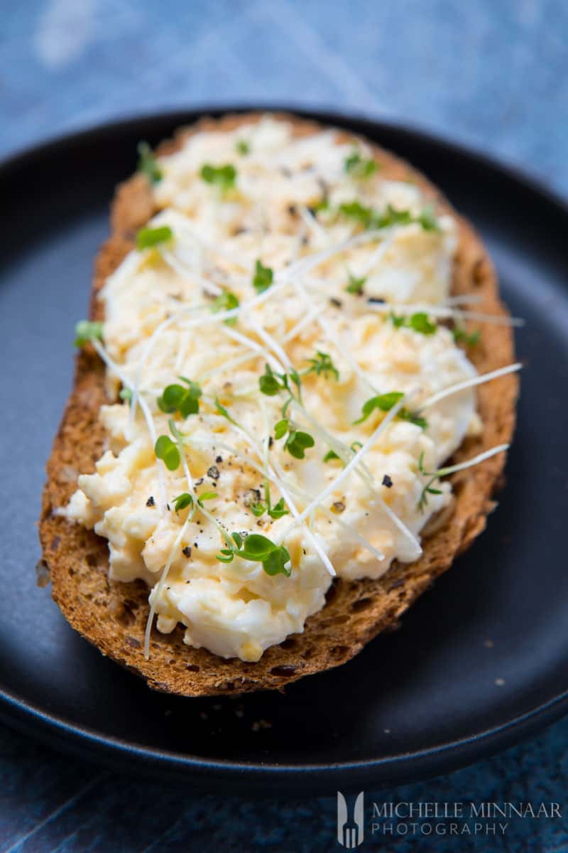 A close up of egg and cress sandwich, egg, brown bread, watercress