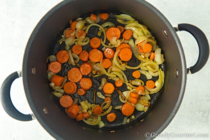 frying carrots and onions.