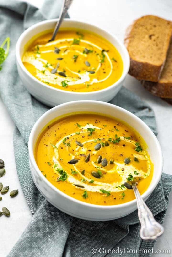 kabocha squash soup served with fresh bread.