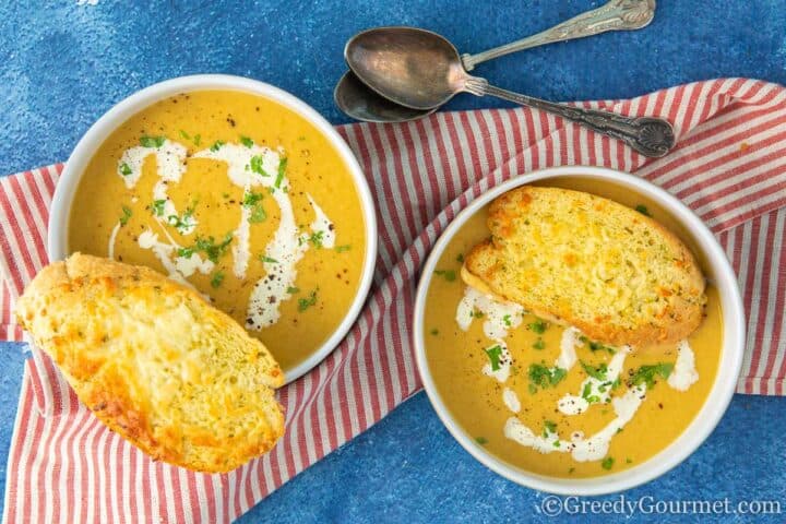 Navy bean soup served with cheesy garlic bread.