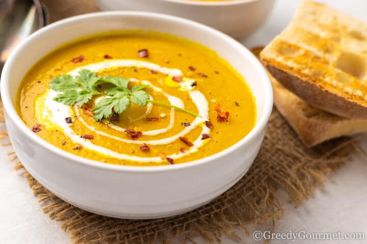 bowls of Curried Pumpkin Bean Soup with fresh bread.
