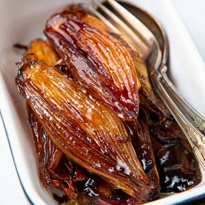 Casserole dish of glazed shallots