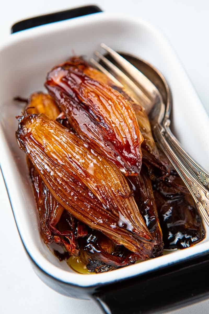 Casserole dish of glazed shallots