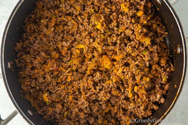 adding mince to vegetables.