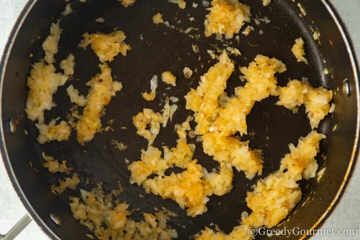 caramelising onion in a pan.