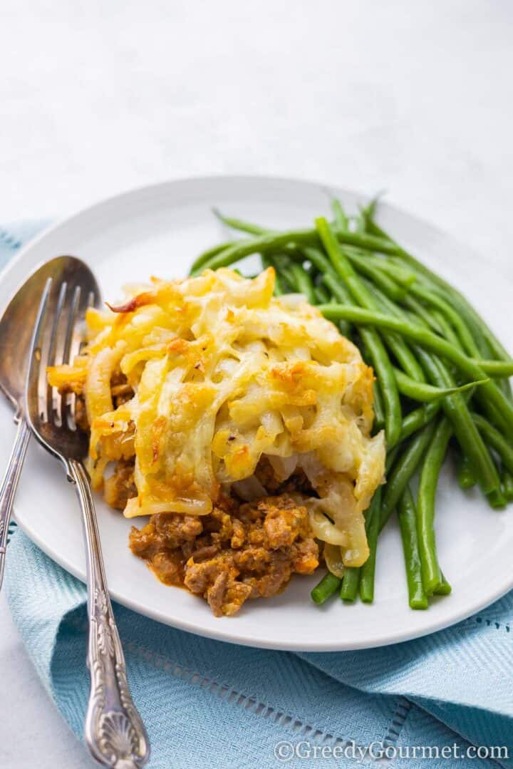 casserole and green beans on a plate.