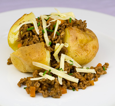 Baked Jacket Potatoes topped with Flavoured Beef Mince & Cheese