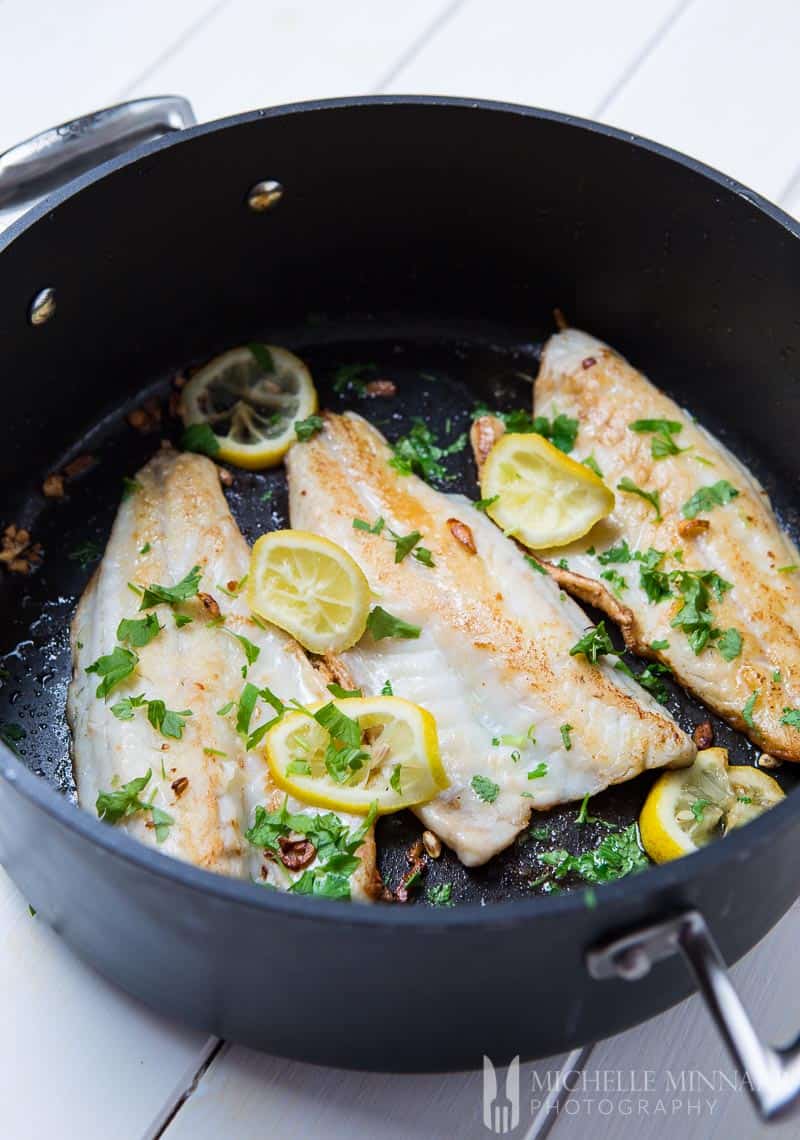 Pan-Fried Seabass With Garlic Lemon Butter Sauce And Spring Vegetables