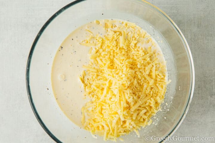 grated cheese and cream in a bowl.