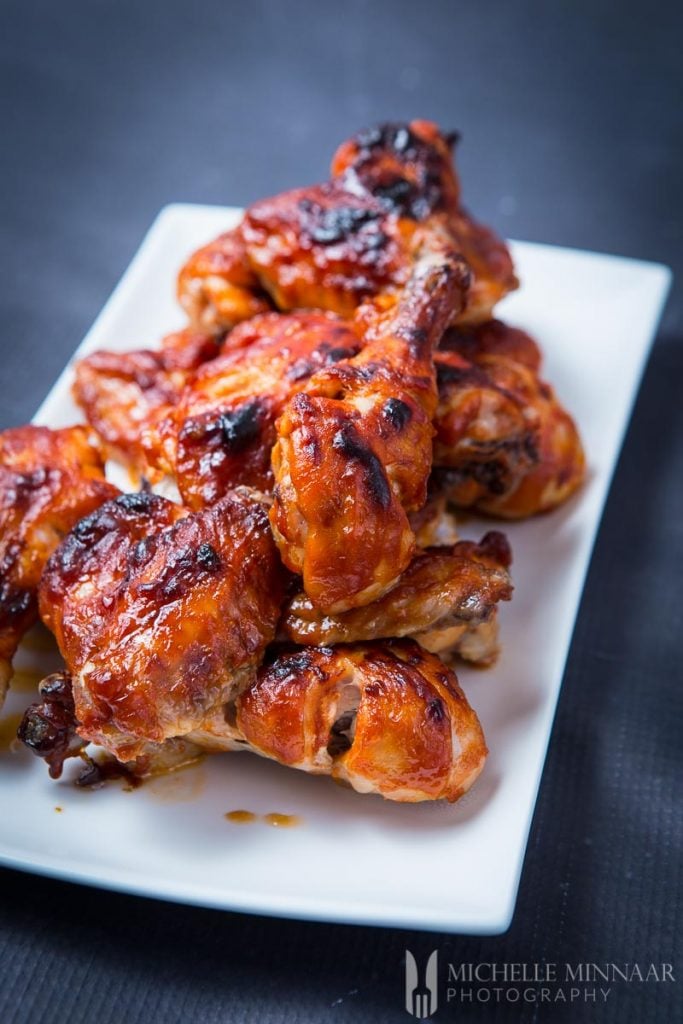 Plate of wings with a barbeque sauce to learn how to reheat chicken wings 