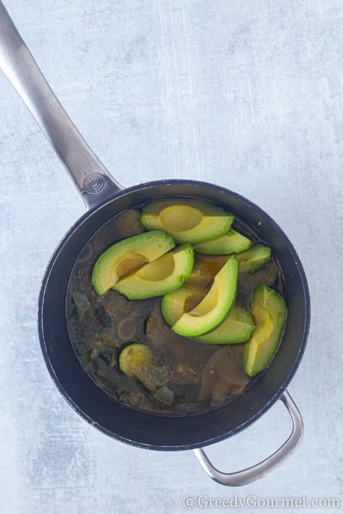 Avocados in a pan to make a vegan avocado soup,