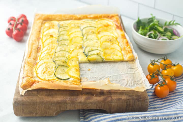 baked tart with tomatoes and salad.