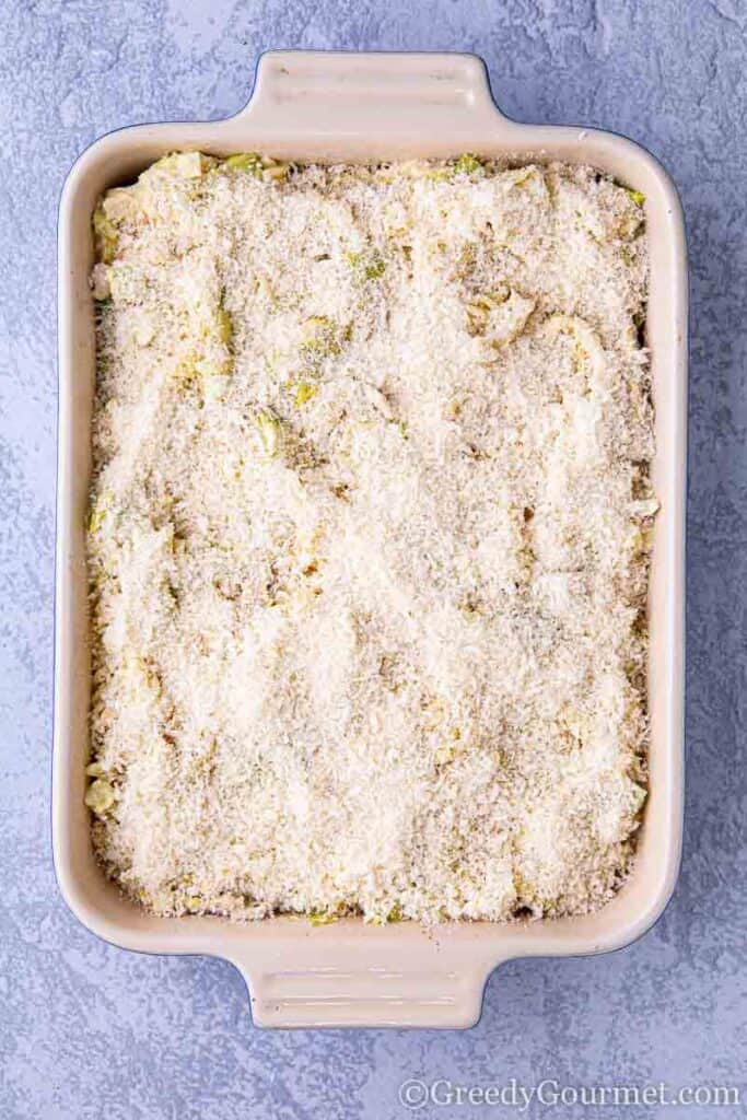 Casserole dish covered in cheese to be baked