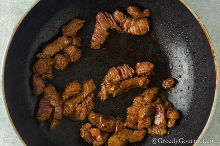 Browning beef in a pan.