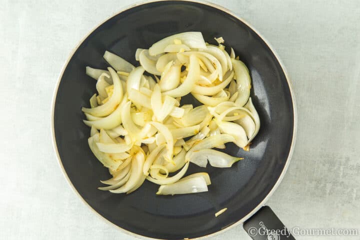 frying onion in a wok.