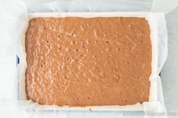 Raw chocolate courgette cake batter in baking tin.