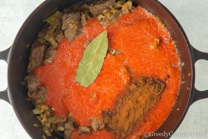 Adding spices to pot.