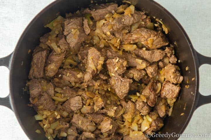 Braised beef and onions in a pot.