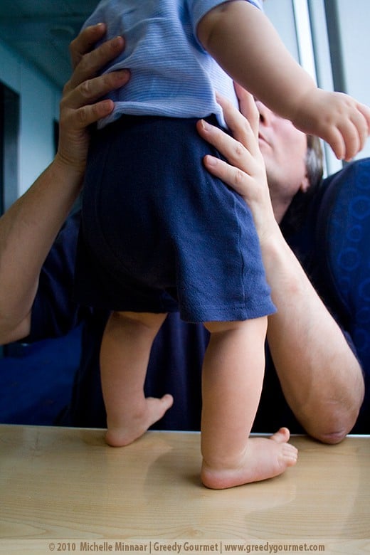 Baby standing on ferry table
