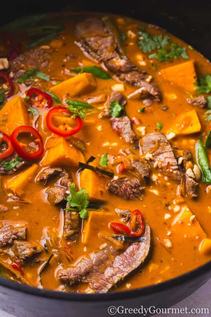 Thai Red Beef Curry cooking in a pot.