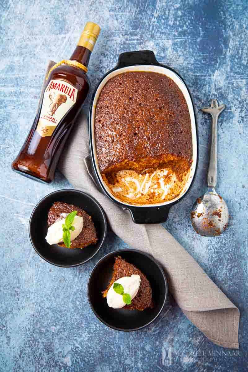 A bottle of amarula and a finsihed Malva Pudding