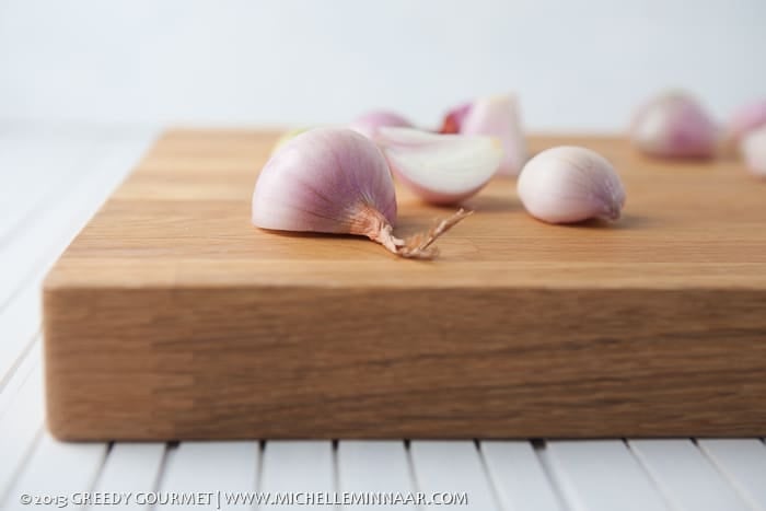 Halved Shallots on Chopping Board