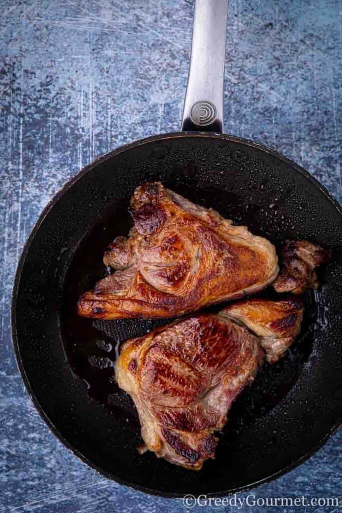 Lamb steaks sauteed in pan 