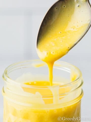 A jar of honey and mustard dressing.