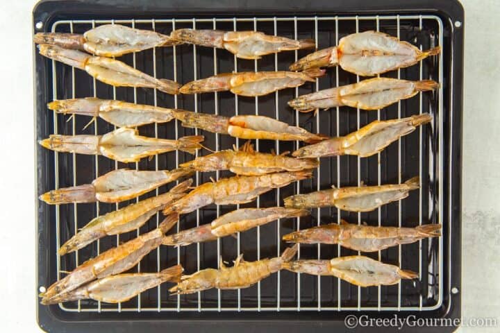 butterflied shrimp raw on the grill.