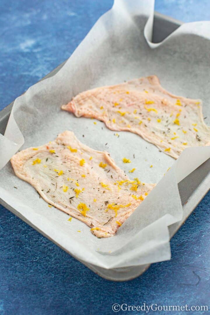 chicken skin ready stretched on an oven tray.