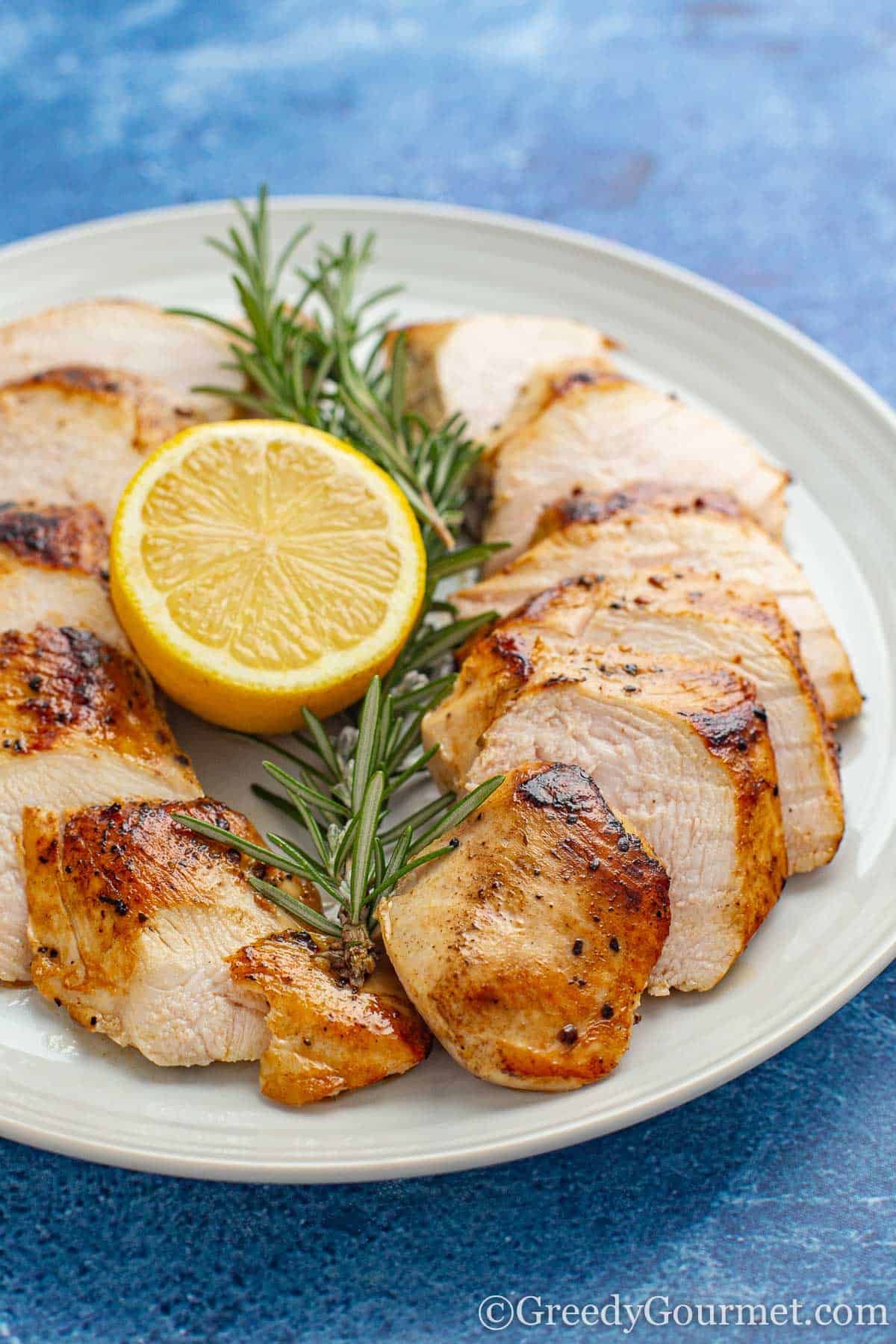 sous vide chicken breast with a slice of lemon and thyme.