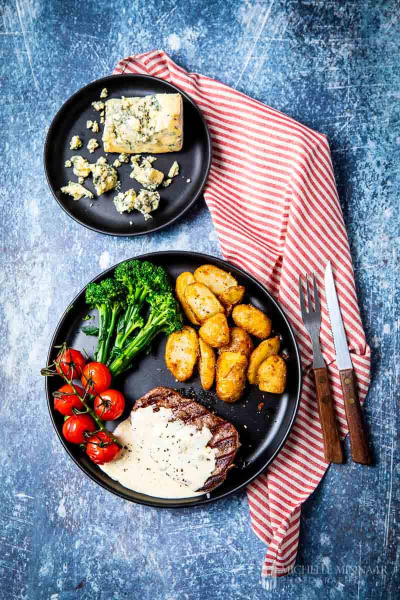 A plate of steak, potatoes and vegetables