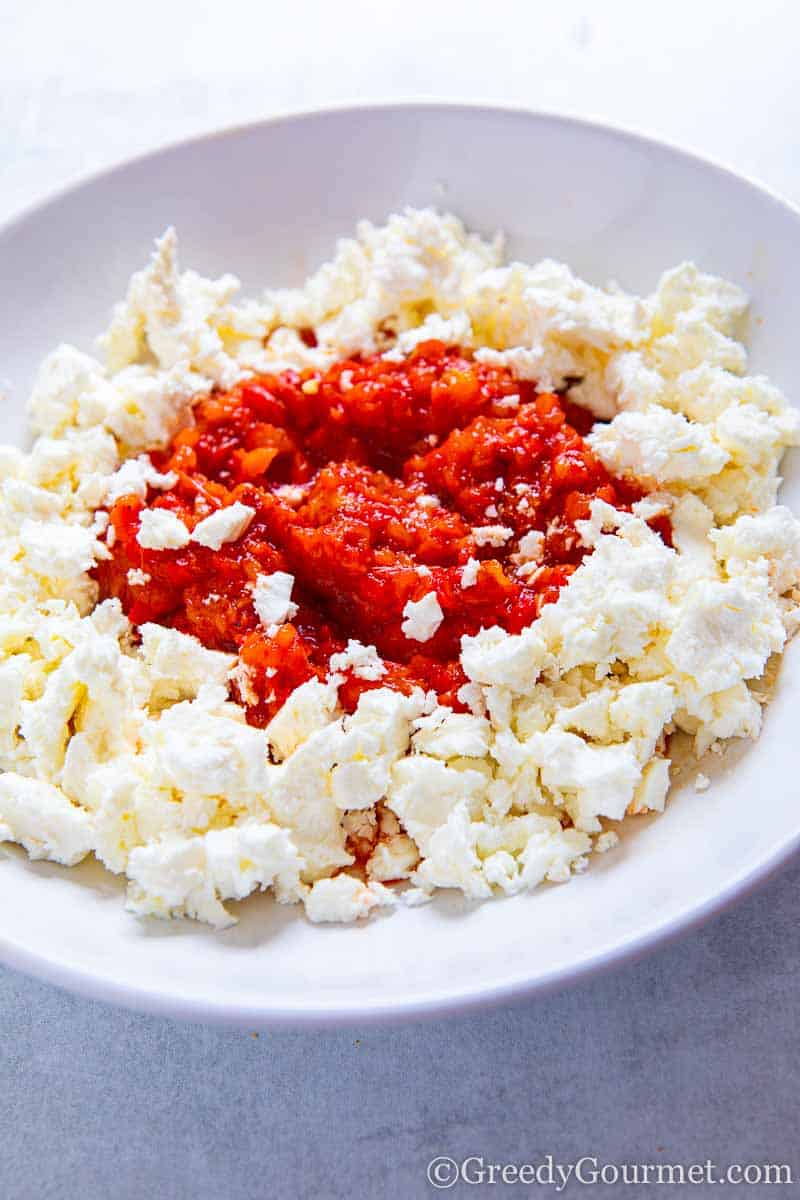 Roasted red peppers on a bed of feta cheese.