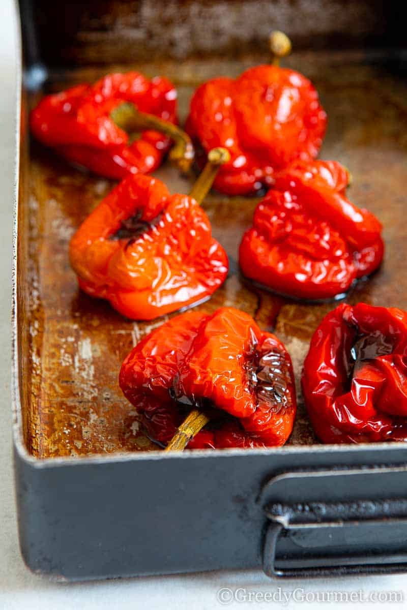 Roasted red peppers in a pan.