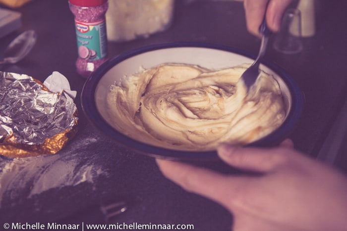 Stirring caramel into icing butter