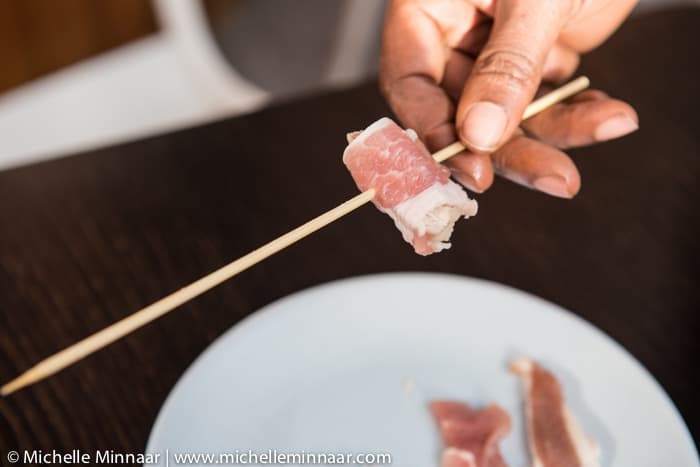 Threading meat on wooden skewer