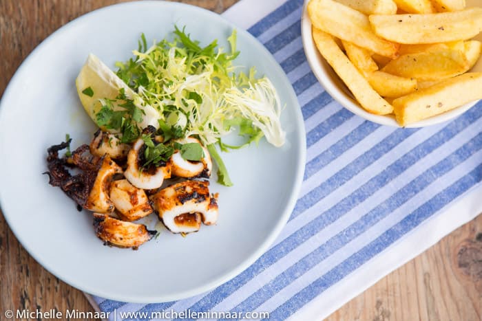 A plate of grilled calamari and fries