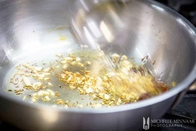 Cumin seeds added to the pan