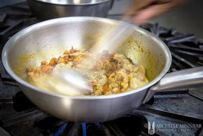 Eggplant and spices being stirred