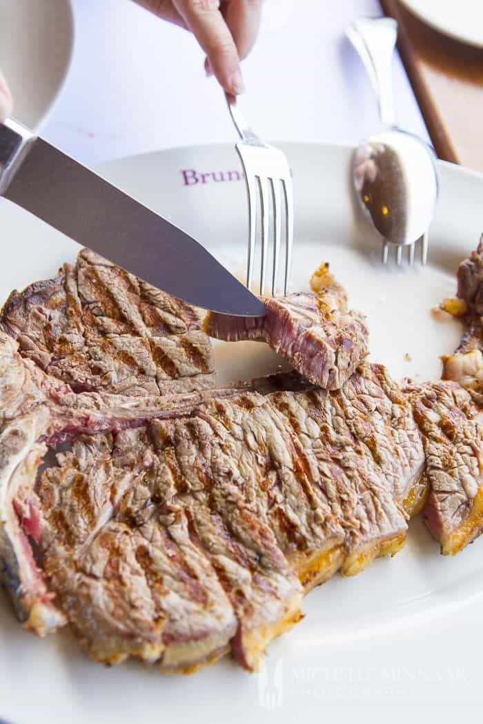 Medium rare steak being sliced