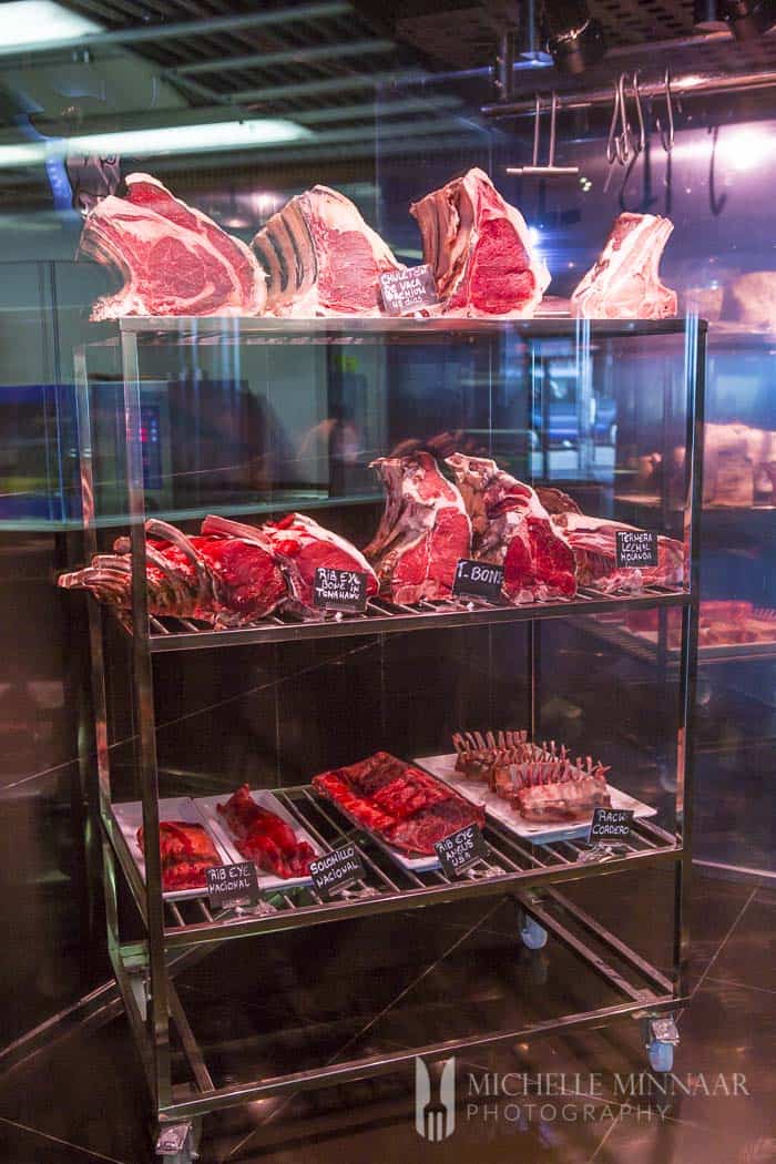 Racks of raw 28 days matured meat in a meat locker