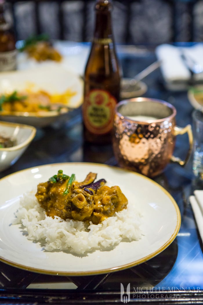 Philippine Dinner, kare kare on a plate of white rice 